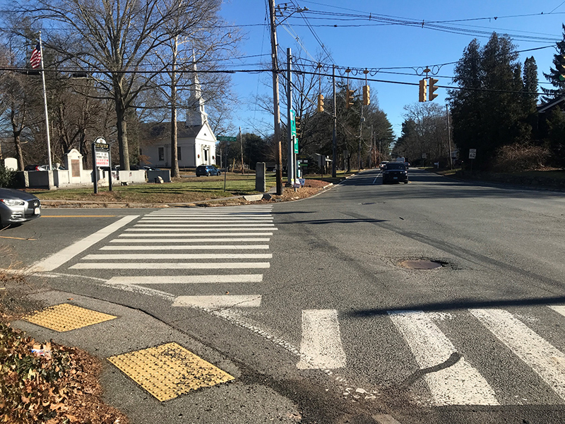 Figure 3 - View across Library Hill Road of Northeast Intersection Corner. Image of crosswalk and the First Parish Church of Stow & Acton.